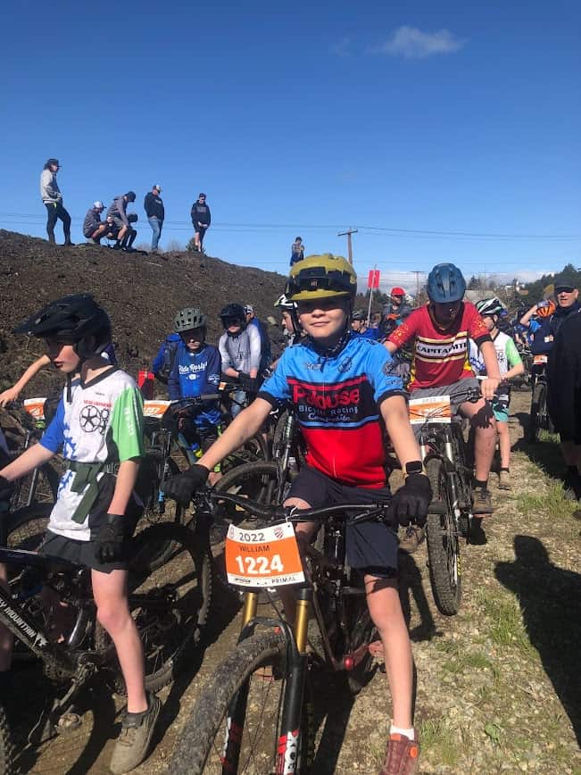 Cyclists waiting to race with spectators in the background